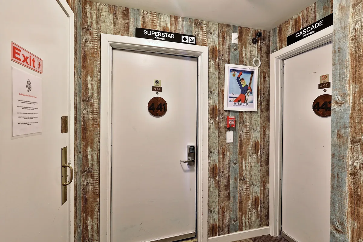 A hallway showing room numbers 441 and 442 alongside the playful 'Superstar' and 'Cascade' signs, enhanced by colorful wall art. The space suggests an atmosphere of adventure and community.